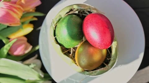 Easter colorful eggs rotate in nest with hey outdoor in sunny warming day. 動画素材 234547856