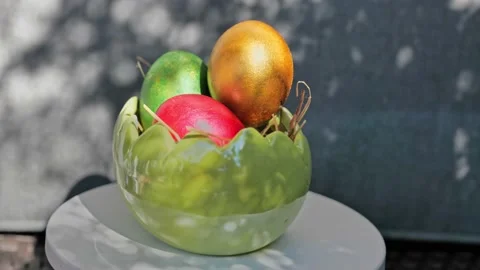 Easter colorful eggs rotate in nest with hey outdoor in sunny warming day. Video stock 234548104