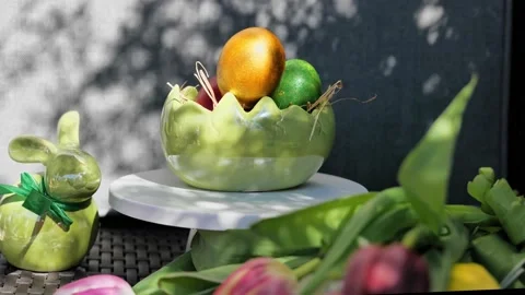 Easter colorful eggs rotate in nest with hey outdoor in sunny warming day. Vídeos de archivo 234548235