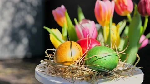 Easter colorful eggs rotate in nest with hey outdoor in sunny warming day. 스톡 동영상 234548485