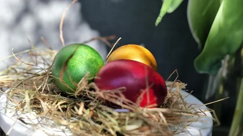 Easter colorful eggs rotate in nest with hey outdoor in sunny warming day. Stock Footage 234548551