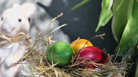 Easter colorful eggs rotate in nest with hey outdoor in sunny warming day. 스톡 동영상 234548674