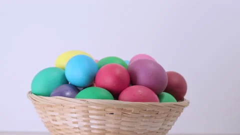 Easter colorful eggs rotating in basket on light background Stock Footage 172149984