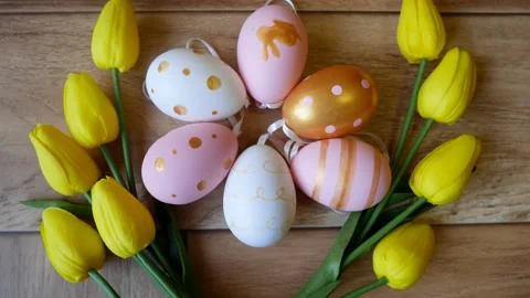 Easter colorful eggs surrounded by yellow tulips Stock Footage 169074026