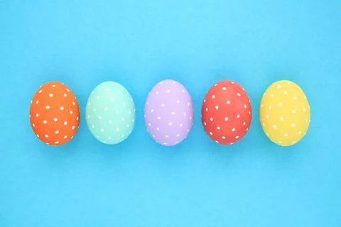 Easter coloured eggs with polka dot on blue background Stock Photos