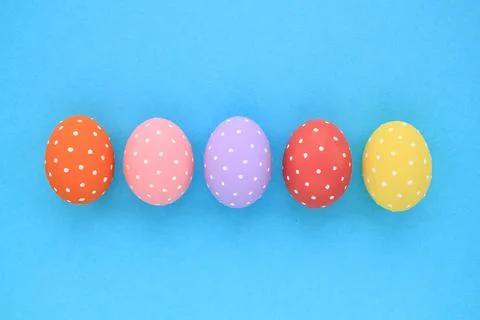 Easter coloured eggs with polka dot on blue background Stock Photos