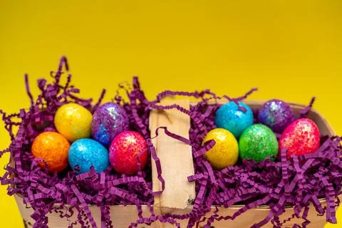 Easter composition from a basket and colored eggs prepared for the holiday on a Stock Photos