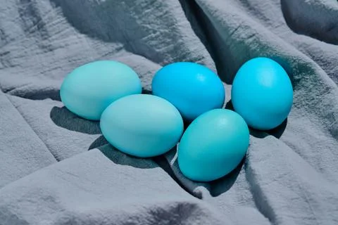 Easter composition in blue shades. Painted eggs on a blue background. Stock Photos