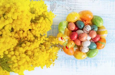 Easter composition. Candy in the shape of Easter eggs on a beautiful ceramic Stock Photos