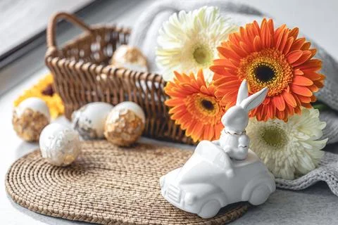 Easter composition with a ceramic hare, gerbera flowers and eggs. Stock Photos