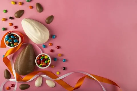 Easter. Composition with chocolate Easter eggs on colored background. Stock Photos