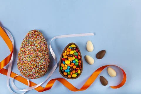 Easter. Composition with chocolate Easter eggs on colored background. Stock Photos