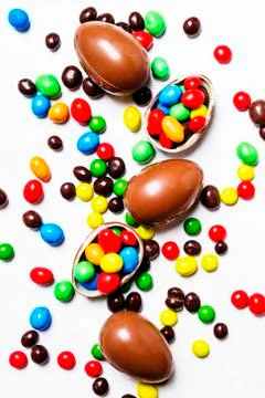 Easter composition with chocolate eggs and colorful candy, white background, Stock Photos