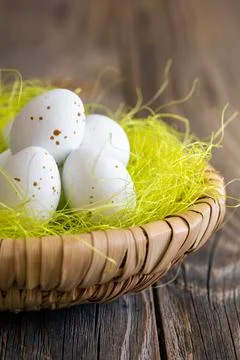 Easter composition with chocolate eggs in a nest on wooden background. Stock Photos