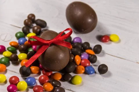 Easter composition with chocolate eggs on white wooden background Stock Photos