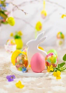 Easter composition with colorful Easter eggs on rabbit dessert plate. Tradi.. Stock Photos
