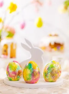 Easter composition with colorful Easter eggs on rabbit dessert plate. Tradi.. Stock Photos