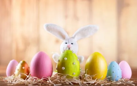 Easter composition with colorful Easter eggs and bunny. Stock Photos