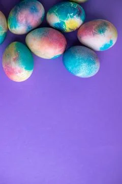 Easter composition with colorful eggs in shopping cart, wooden bunny and spri Stock Photos