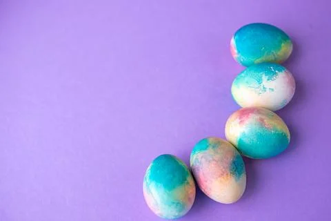 Easter composition with colorful eggs in shopping cart, wooden bunny and spri Stock Photos