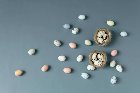 Easter composition with colourful Easter eggs in bird's nest on blue background Stock Photos