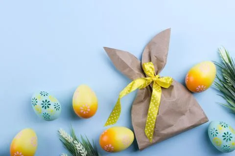 Easter composition with craft paper package in the shape of.bunny, colorful Stock Photos