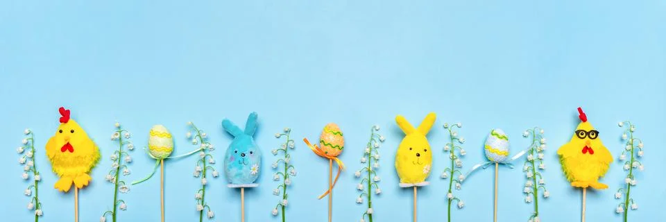 Easter composition with decorative easter bunnies, chickens, eggs and lilies  Stock Photos