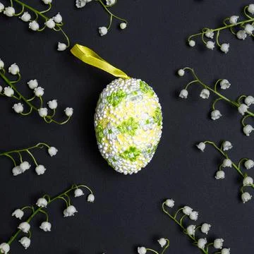 Easter composition with decorative easter egg and fresh white lilies of the v Stock Photos
