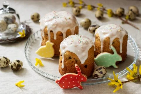 Easter composition of Easter cakes, biscuits, eggs and forsythia flowers. Rus Stock Photos