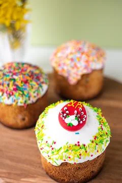 Easter composition with Easter cakes, wooden stand and spring flowers on a .. Stock Photos