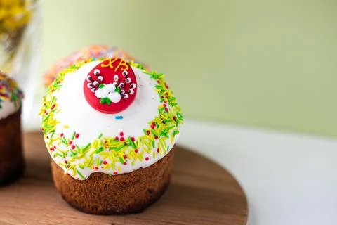 Easter composition with Easter cakes, wooden stand and spring flowers on a .. Stock Photos