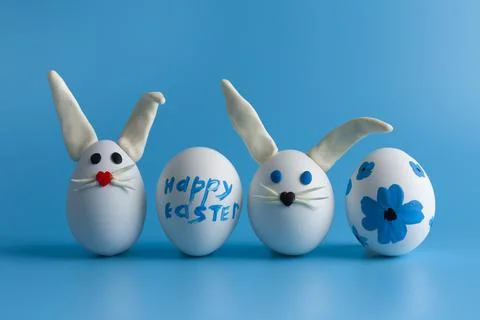 Easter composition with Easter eggs decorated flowers and Easter bunny. Stock Photos