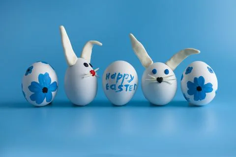 Easter composition with Easter eggs decorated flowers and Easter bunny. Stock Photos