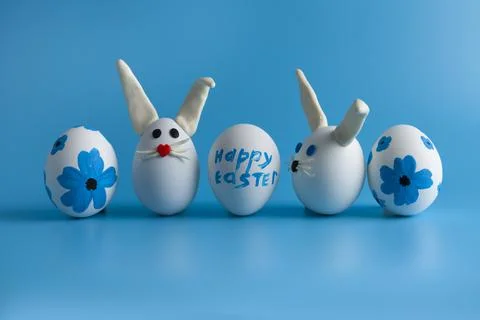 Easter composition with Easter eggs decorated flowers and Easter bunny. Stock Photos