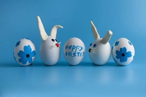 Easter composition with Easter eggs decorated flowers and Easter bunny. Stock Photos