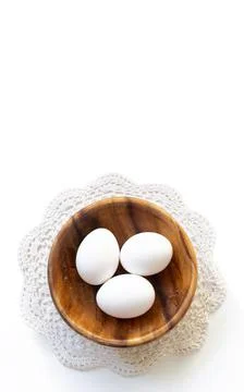 Easter composition. Easter eggs in a wooden plate on a white background. East Stock Photos
