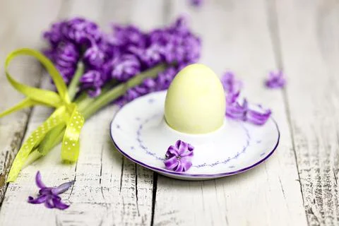 Easter composition with egg and egg cup with Hyacinth spring flowers on woode Stock Photos