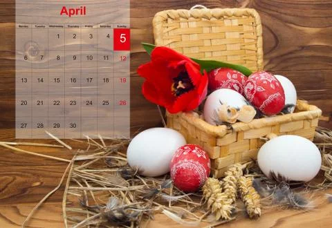Easter composition with eggs and flower tulip in a basket with a calendar for Stock Photos