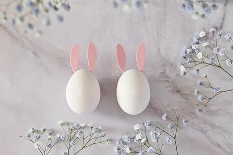 Easter composition of eggs and flowers on a light background. Easter bunny. A Stock Photos