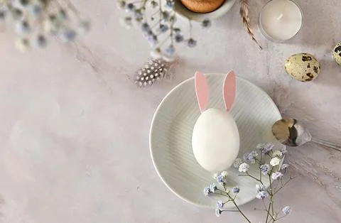 Easter composition of eggs and flowers on a light background. Easter bunny. A Stock Photos