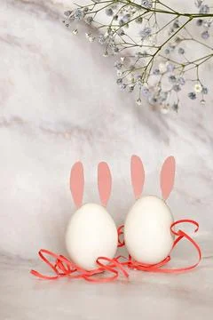Easter composition of eggs and flowers on a light background. Easter bunny. A Stock Photos