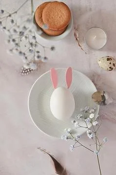 Easter composition of eggs and flowers on a light background. Easter bunny. A Stock Photos