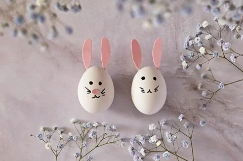 Easter composition of eggs and flowers on a light background. Easter bunny. A Stock Photos