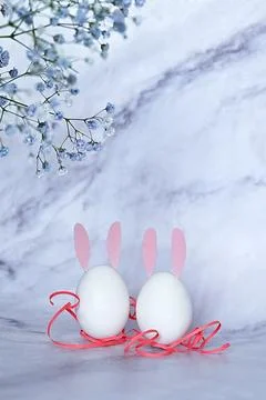 Easter composition of eggs and flowers on a light background. Easter bunny. A Stock Photos