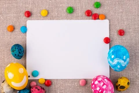 Easter composition with eggs on a linen surface. White card for an inscriptio Stock Photos