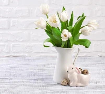 Easter composition with eggs, spring tulips and porcelain easter bunny on old Stock Photos