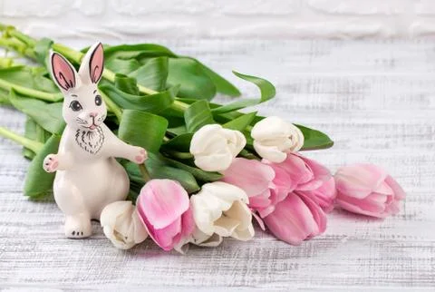 Easter composition with eggs, spring tulips and porcelain easter bunny on old Stock Photos