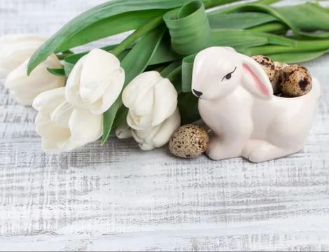 Easter composition with eggs, spring tulips and porcelain easter bunny on old Stock Photos