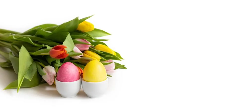 Easter composition with eggs in stands and a bouquet of spring flowers  Stock Photos