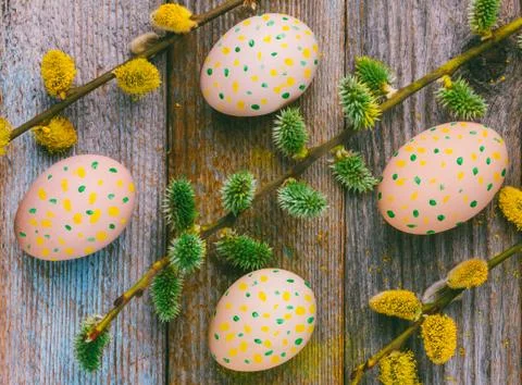 Easter composition of flowering willow twigs and Easter eggs with a simple pa Stock Photos